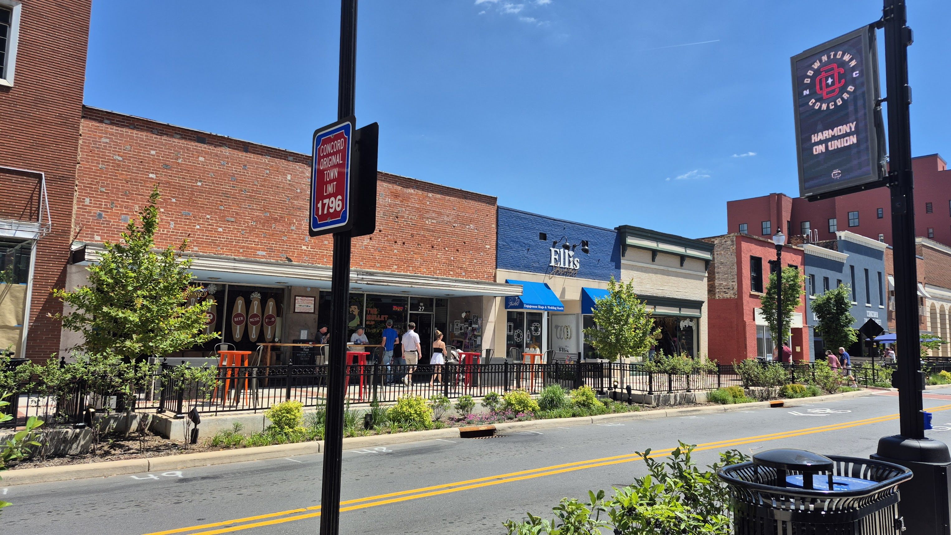 Union Street patio social scene with the OG sign and district directory
